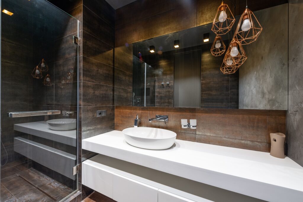 Bathroom decor ideas featuring a modern bathroom with stylish storage, mirror, lighting, and elegant accessories
